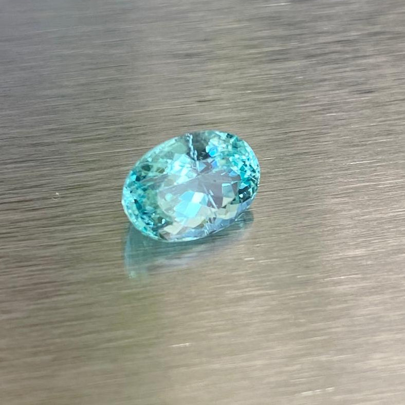 1.71 ct GIA-certified Paraiba-type tourmaline, angled oval view showing bright blue-green brilliance.