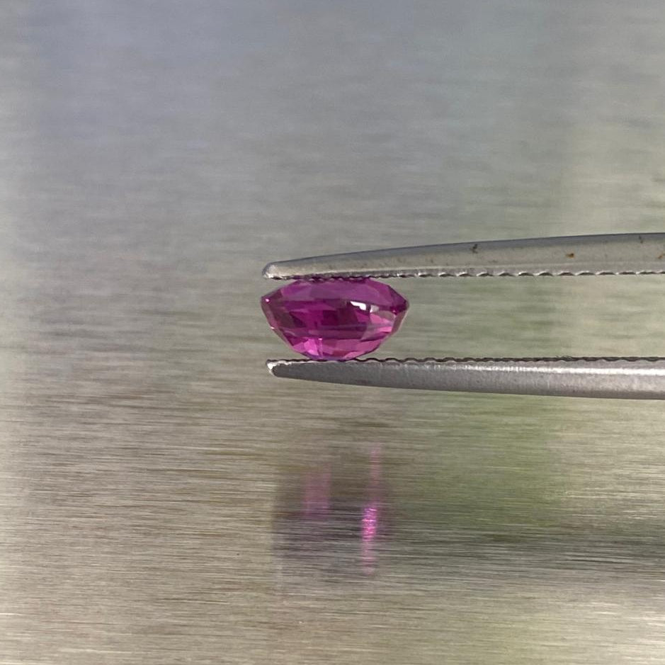 1.15 ct natural Sri Lankan ruby held in tweezers, side profile view showing crown and pavilion