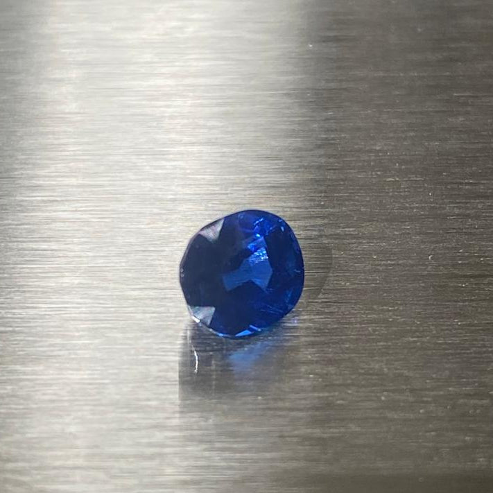 1.27 ct unheated Cambodian royal blue sapphire, angled face-up view in natural light
