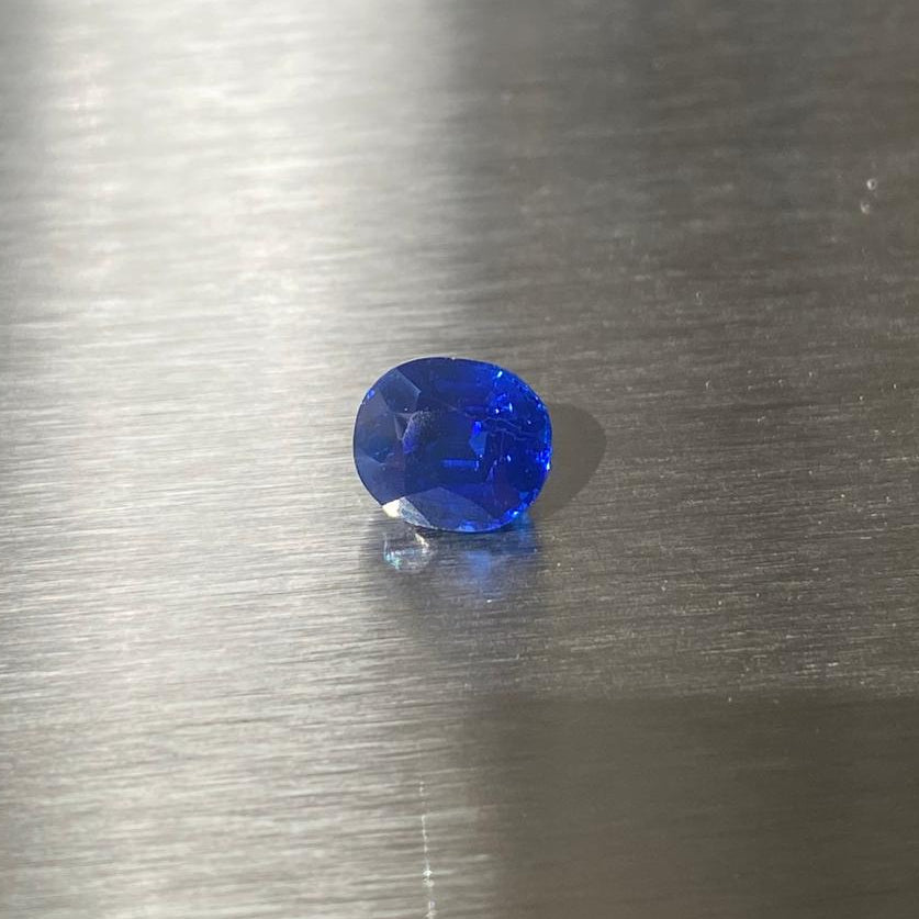1.27 ct unheated Cambodian royal blue sapphire, face-up view in natural light