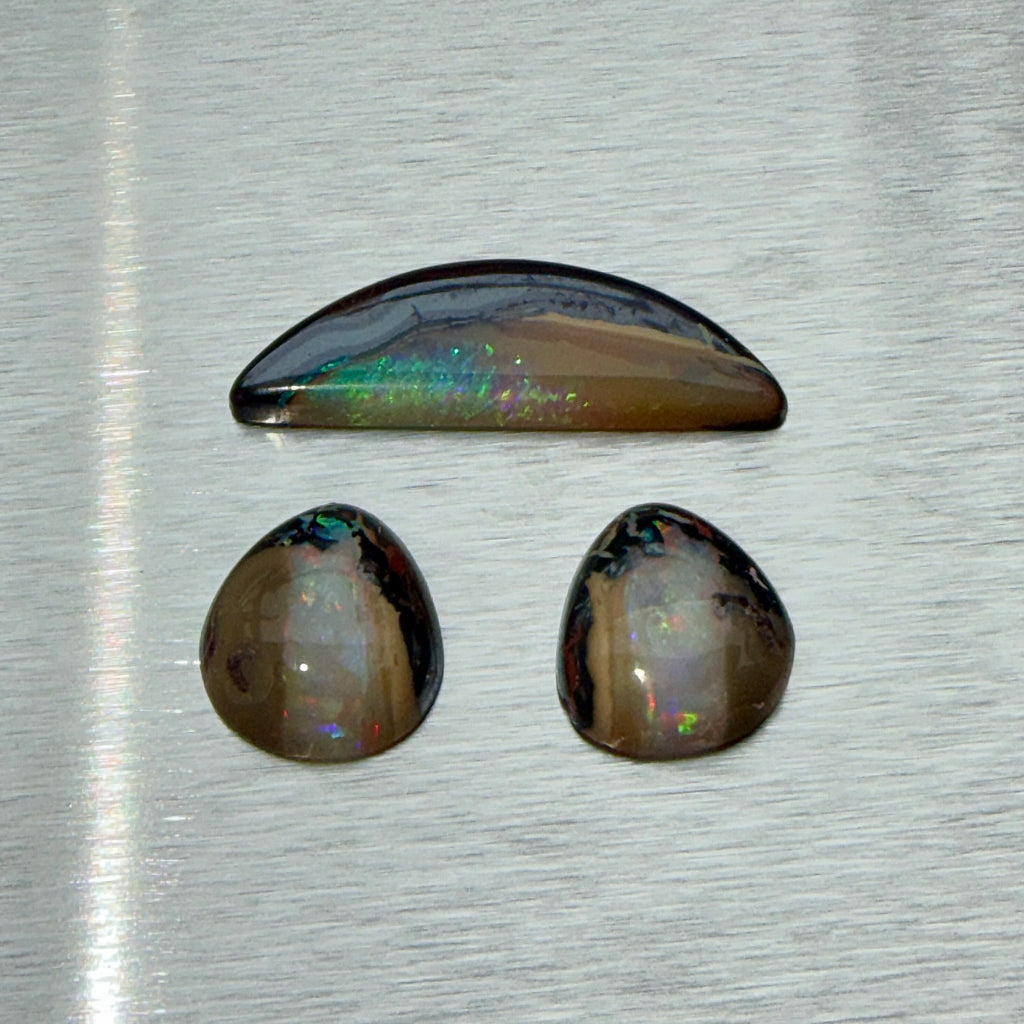 Australian boulder opal suite with matched pair and crescent cabochon, play-of-color view, Otzera OTZ-2026-00328