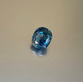 2.14 ct steel-blue cushion-cut sapphire shown from multiple angles, Otzera OTZ-2026-01625