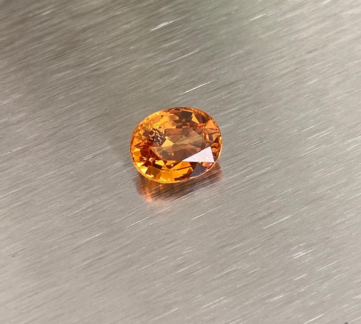 2.14 ct vivid orange oval spessartite garnet shown from multiple angles, Otzera OTZ-2026-01626