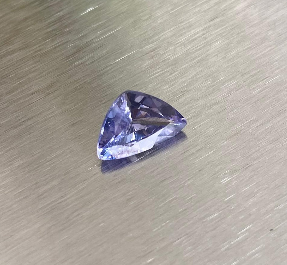 1.85 ct purple sapphire, angled view on metallic background