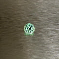 1.70 ct Merelani mint grossular garnet held face-up in tweezers, round modified brilliant cut, Otzera OTZ-2026-01636