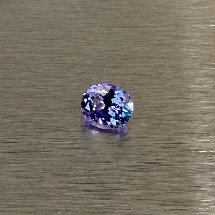 1.57 ct natural purple sapphire oval modified brilliant face-up on brushed metal