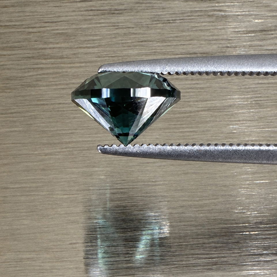 2.32 ct natural green sapphire round brilliant side profile held in tweezers