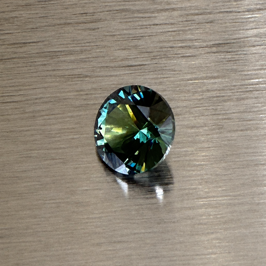 2.32 ct natural green sapphire round brilliant showing blue-green flashes