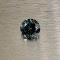 2.32 ct natural green sapphire round brilliant face-up on brushed metal