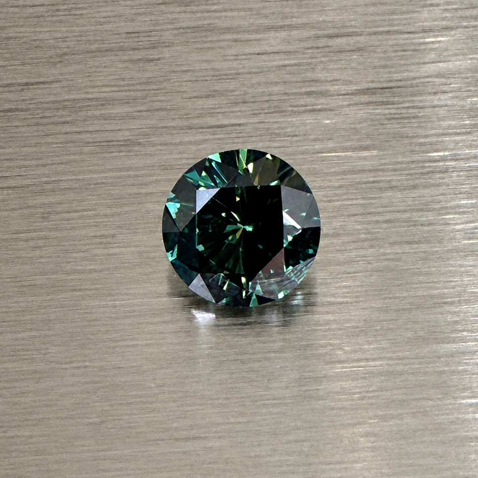2.32 ct natural green sapphire round brilliant face-up on brushed metal
