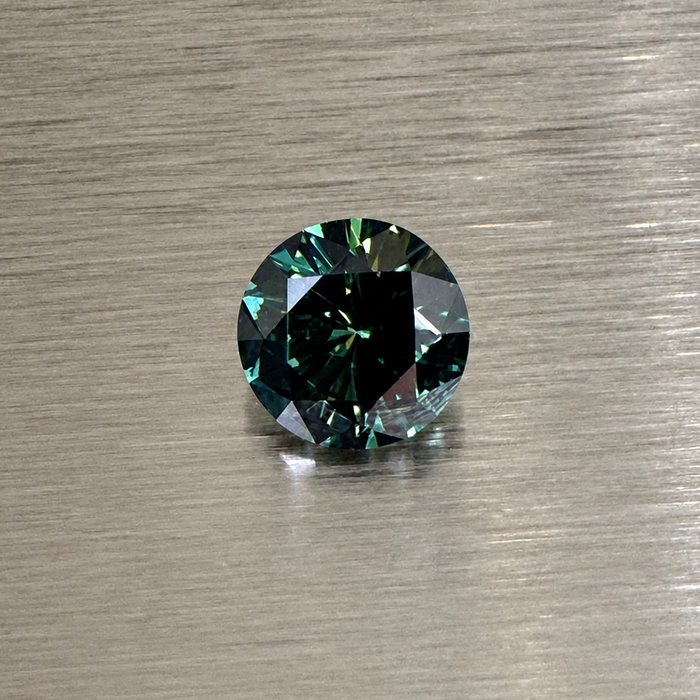 2.32 ct natural green sapphire round brilliant face-up on brushed metal