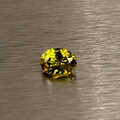 2.22 ct natural Andradite garnet showing olive green and golden flashes