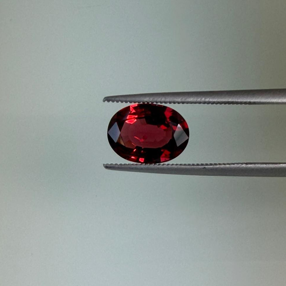 2.13 ct natural red spinel held in tweezers, face-up view, Otzera OTZ-2026-01643