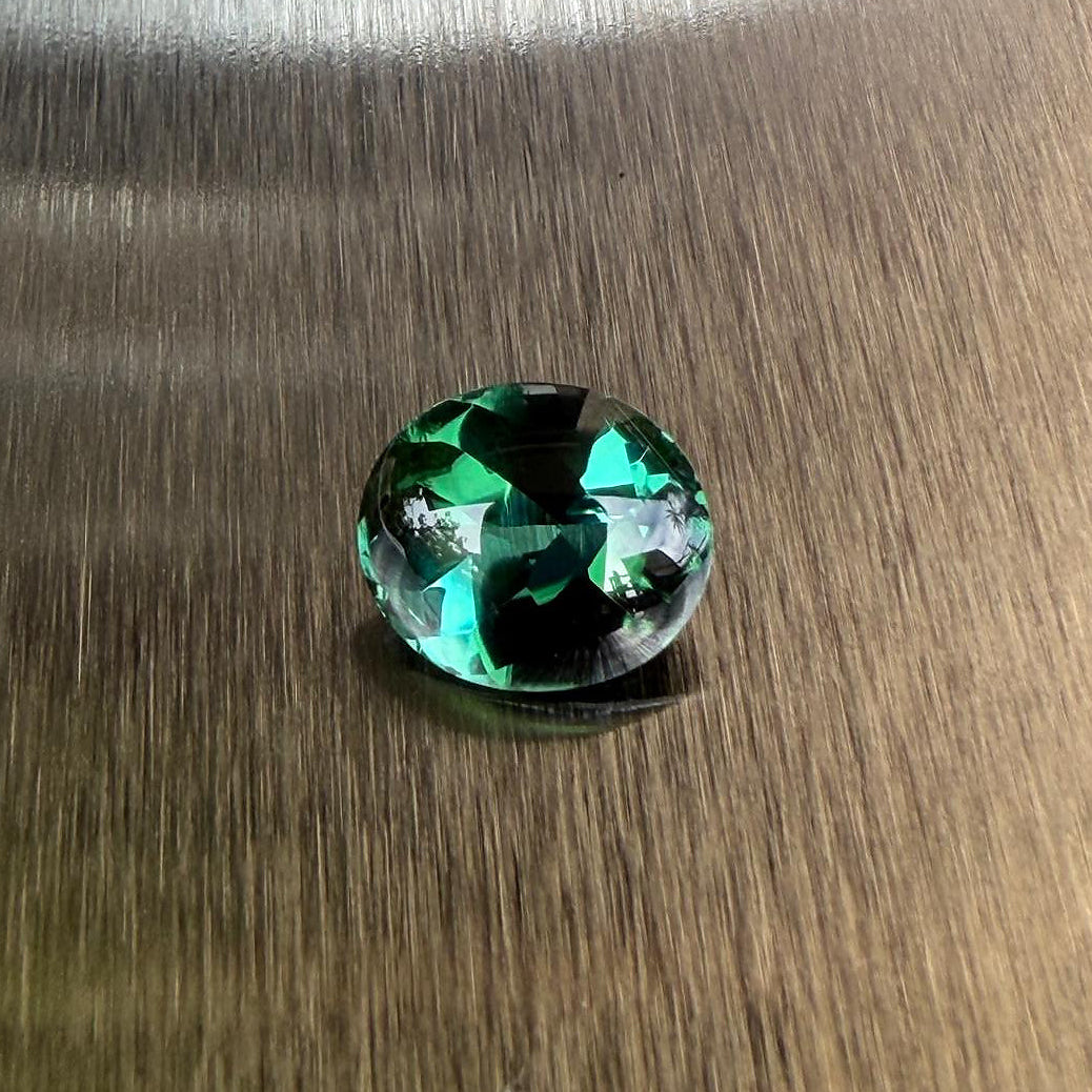 2.98 ct natural blue-green tourmaline from Namibia in an oval buff top modified brilliant cut, shown from multiple angles, Otzera OTZ-2026-01646