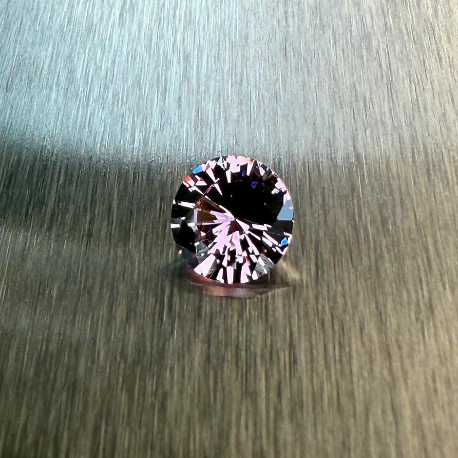1.28 ct natural purple spinel from Vietnam in a round brilliant cut, shown from multiple angles, Otzera OTZ-2026-01647