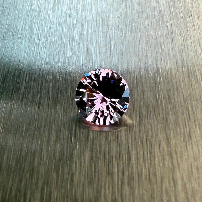 1.28 ct natural purple spinel from Vietnam in a round brilliant cut, shown from multiple angles, Otzera OTZ-2026-01647
