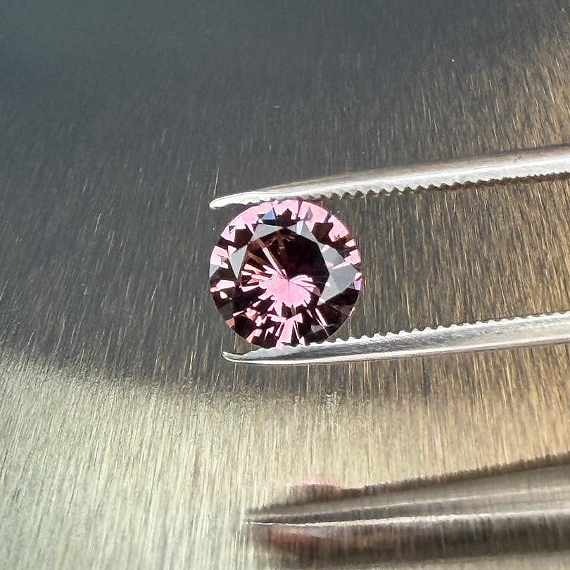 1.28 ct natural purple spinel from Vietnam in a round brilliant cut, shown from multiple angles, Otzera OTZ-2026-01647