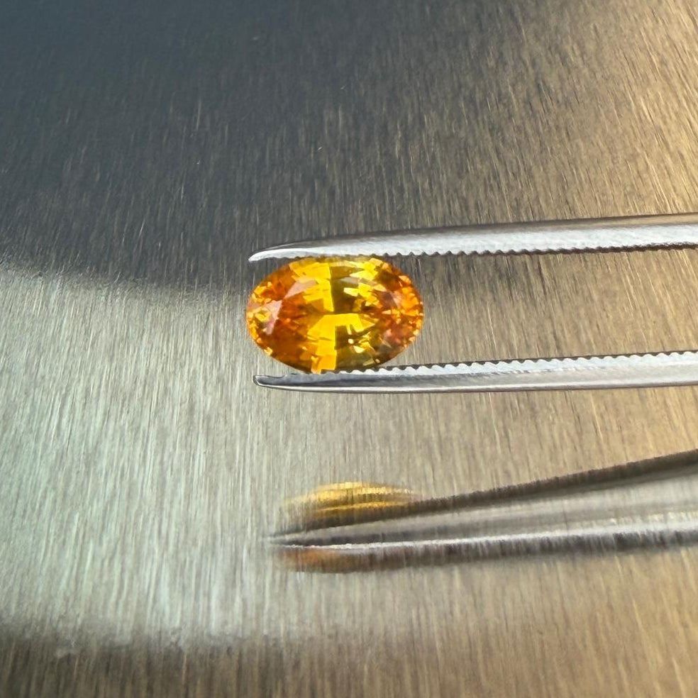 1.38 ct natural yellow sapphire from Sri Lanka in an oval mixed cut, tweezer face-up view, Otzera OTZ-2026-01648