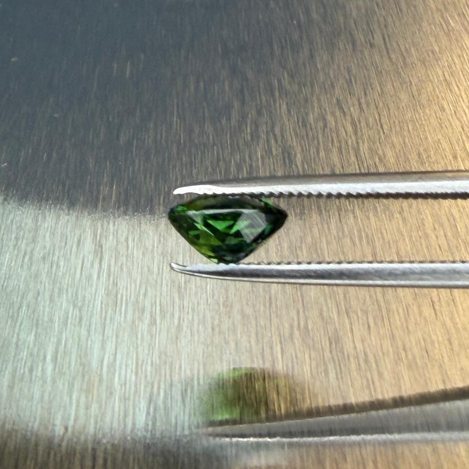 1.20 ct Brazilian blue-green tourmaline held in tweezers, side profile, Otzera OTZ-2026-01650