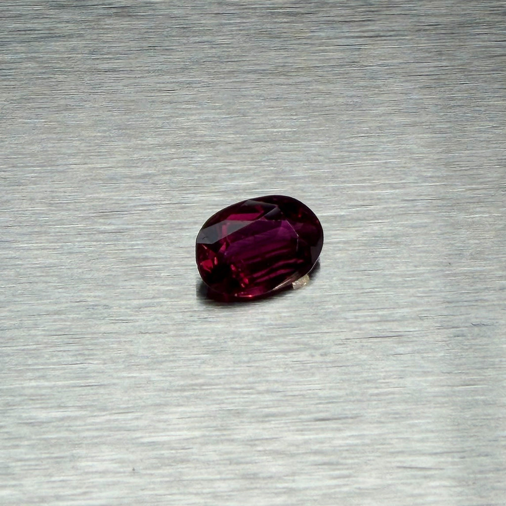 1.82 ct natural ruby, oval mixed cut, angled face-up view showing purplish-red color, Otzera OTZ-2026-01662