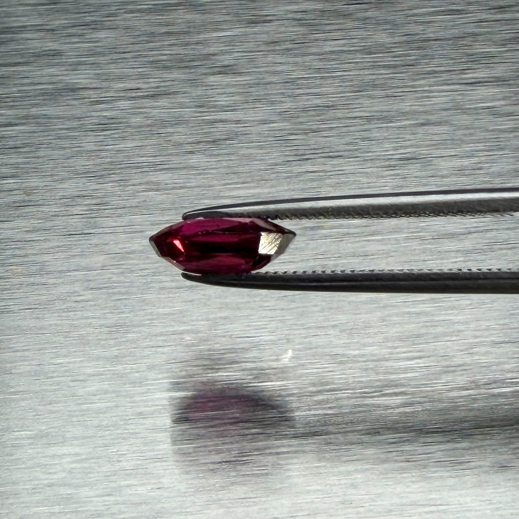 1.82 ct natural ruby held in tweezers, side profile showing cut depth, Otzera OTZ-2026-01662