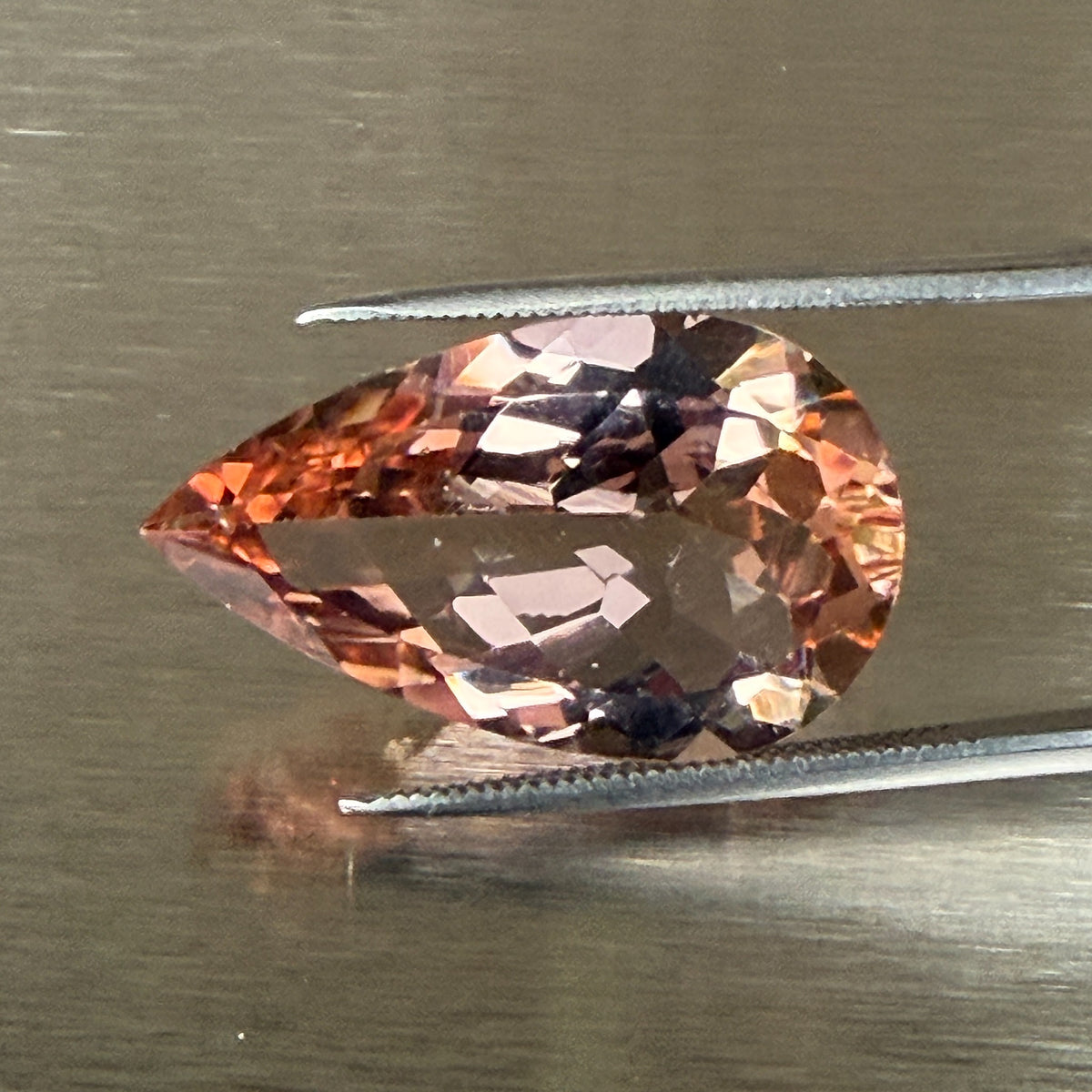 15.18 ct natural morganite held in tweezers, face-up pear view, Otzera OTZ-2026-01669