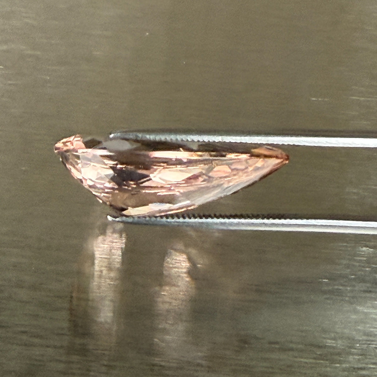 15.18 ct natural morganite held in tweezers, side profile showing cut depth, Otzera OTZ-2026-01669
