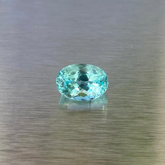 1.71 ct GIA-certified Paraiba-type tourmaline, face-up oval view showing vivid green-blue color.