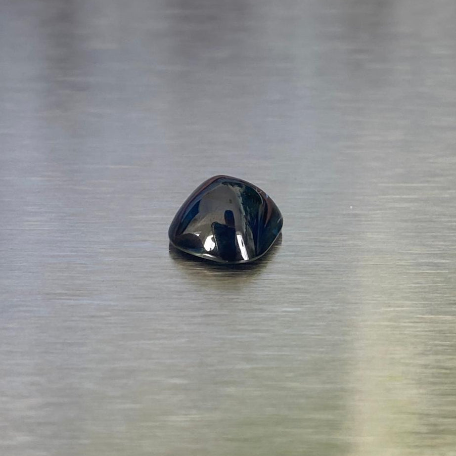 2.41 ct unheated Australian blue sapphire, angled cushion sugarloaf cabochon view showing the polished dome.