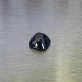 2.41 ct unheated Australian blue sapphire, cushion sugarloaf cabochon front view on a brushed silver background.